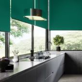 Modern green roller blinds installed in a luxury Clitheroe kitchen